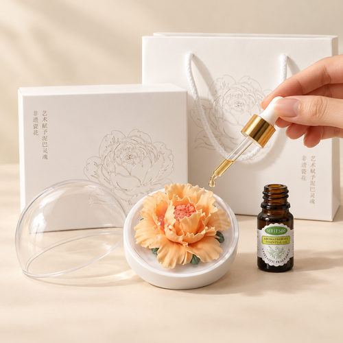 Apricot ceramic peony flower and oil gift set, large version — oil being dropped onto the ceramic flower petals