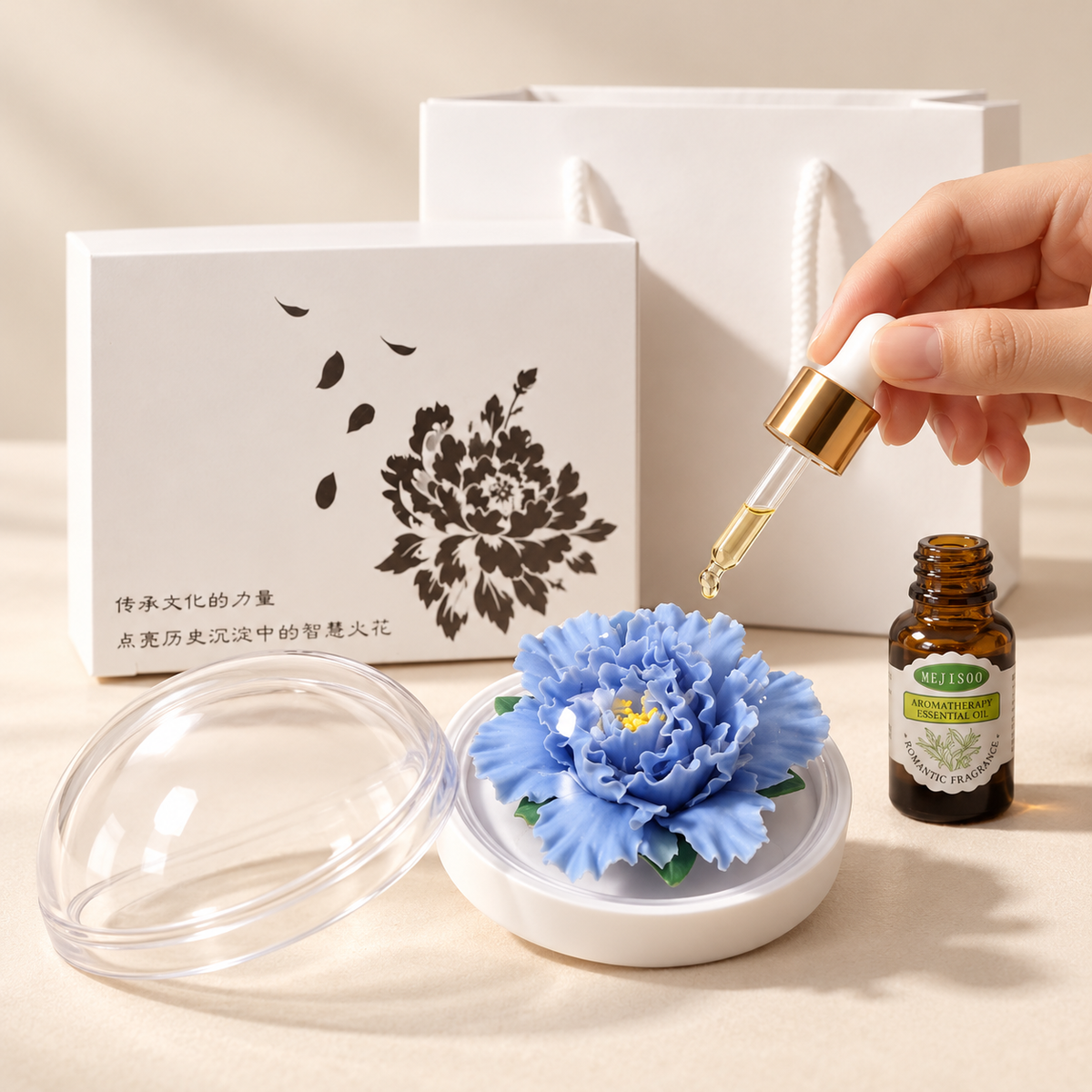 Blue ceramic peony flower and oil gift set, compact version — oil being dropped onto the ceramic flower petals