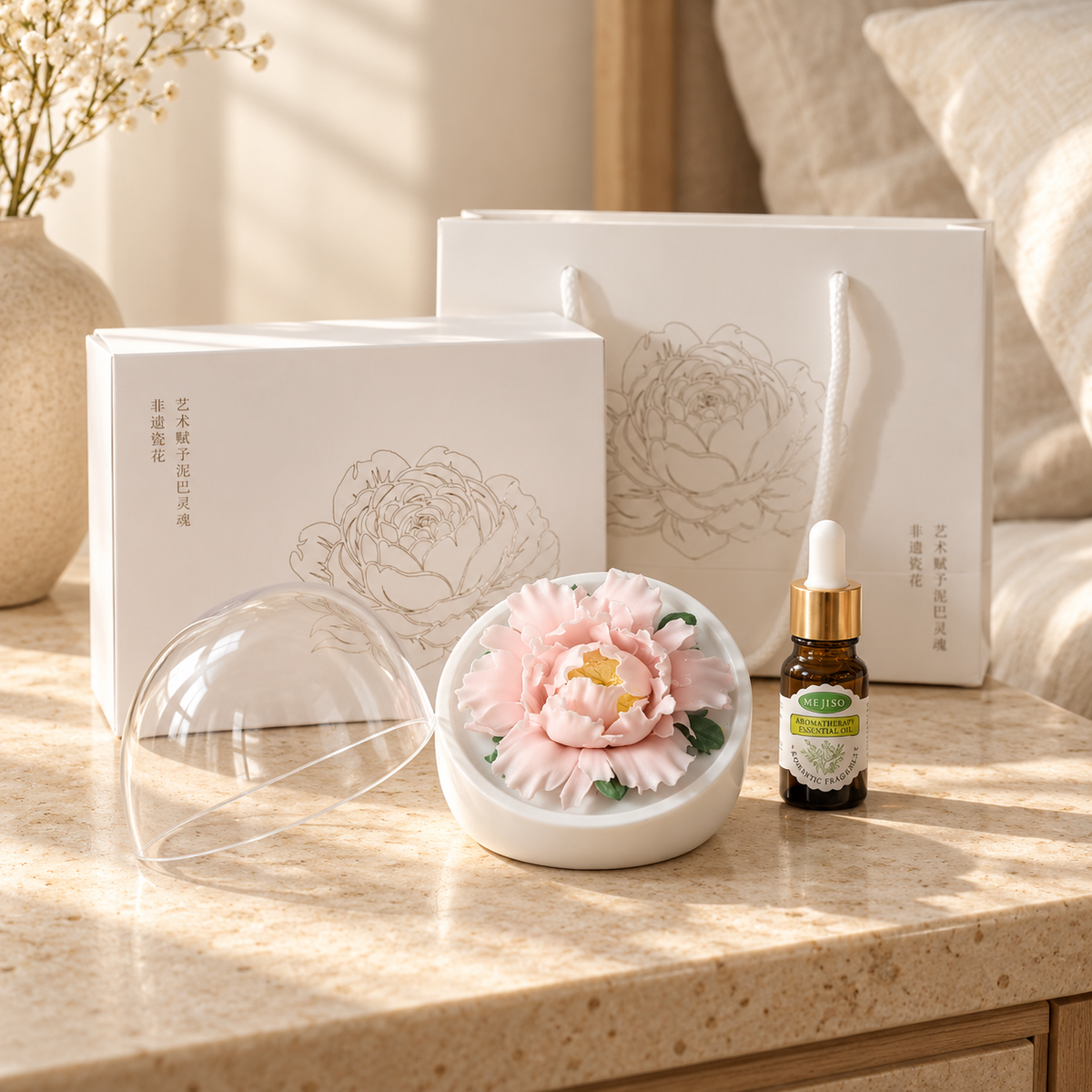 Blush Pink ceramic peony flower and oil gift set, large version — gift set styled on a bedside table in a beige room