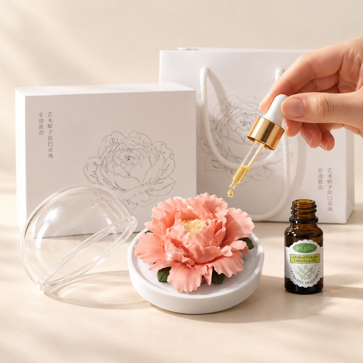 Coral ceramic peony flower and oil gift set, large version — oil being dropped onto the ceramic flower petals