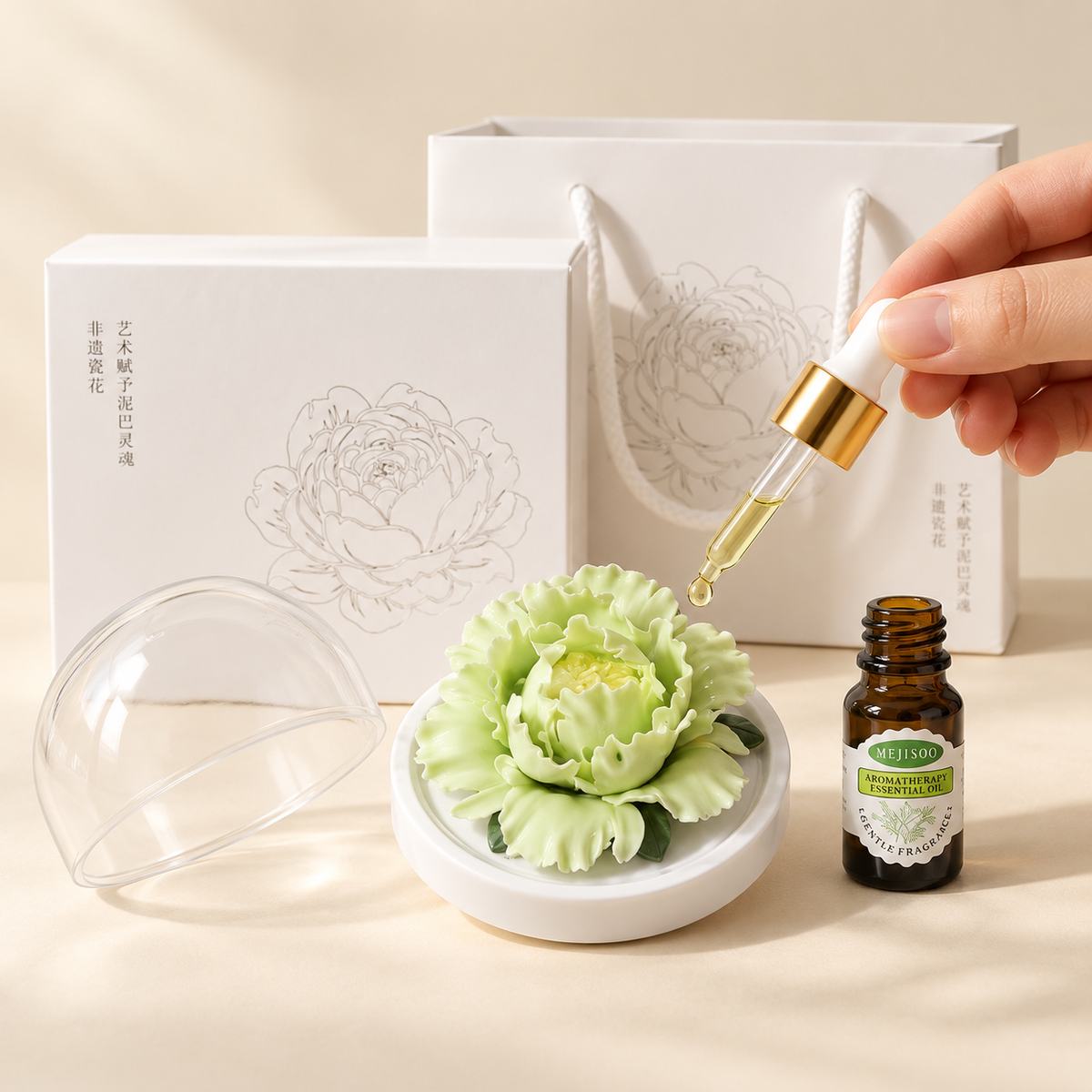 Green ceramic peony flower and oil gift set, large version — oil being dropped onto the ceramic flower petals
