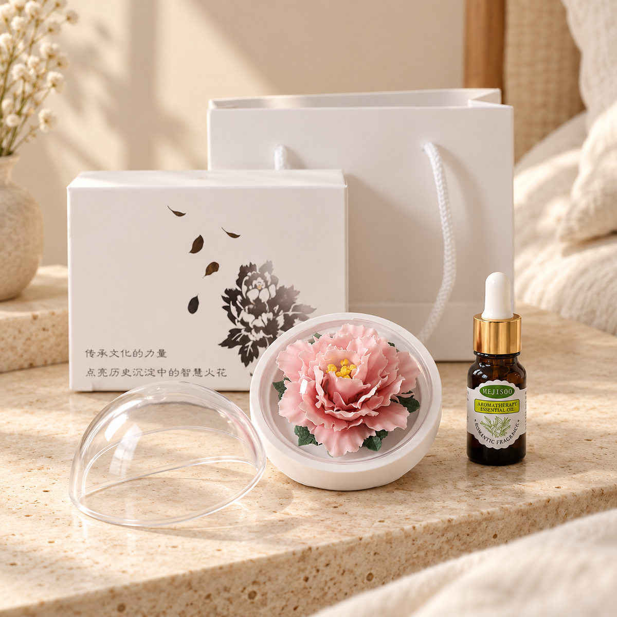Pink ceramic peony flower and oil gift set, compact version — gift set styled on a bedside table in a beige room