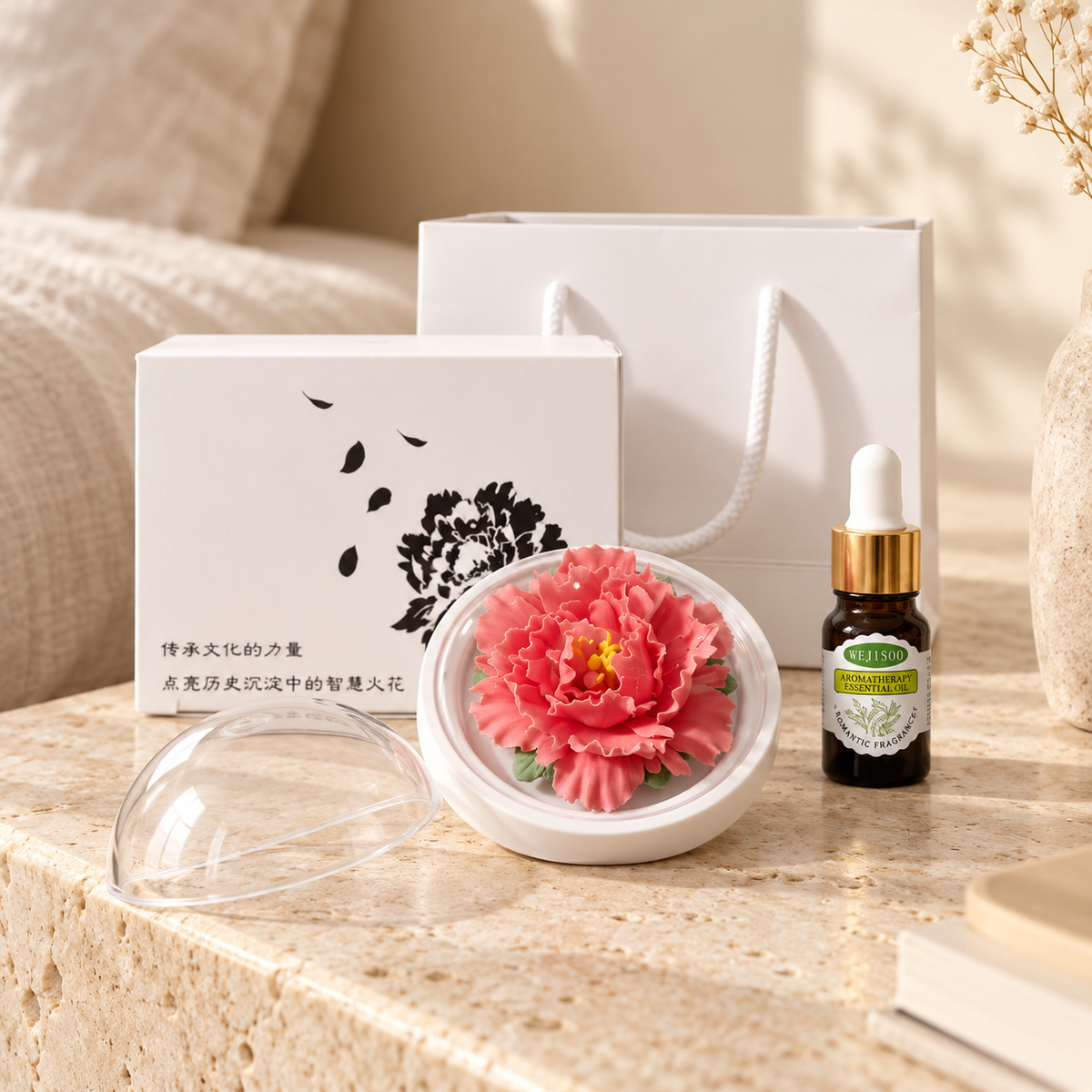 Red ceramic peony flower and oil gift set, compact version — gift set styled on a bedside table in a beige room