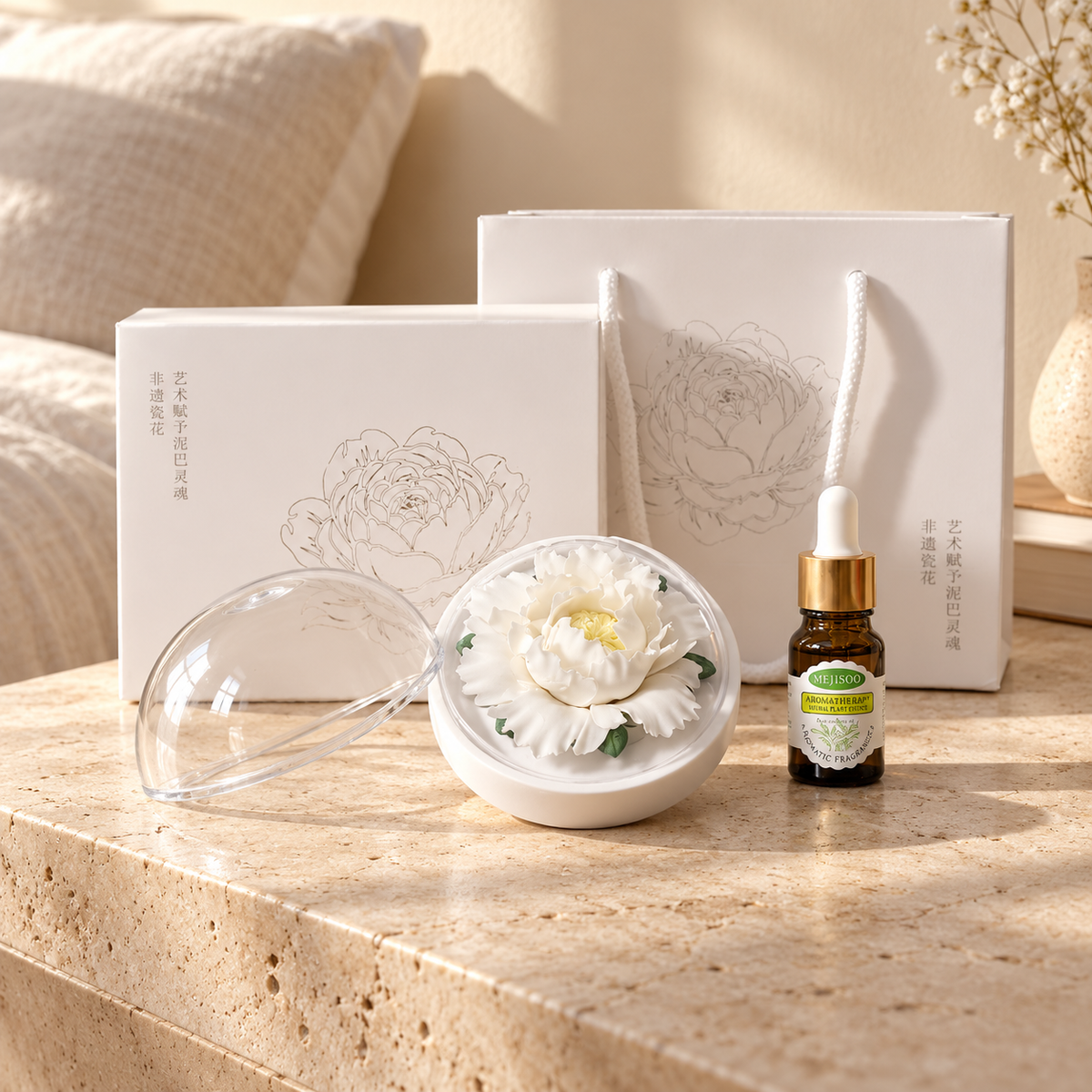 White ceramic peony flower and oil gift set, large version — gift set styled on a bedside table in a beige room