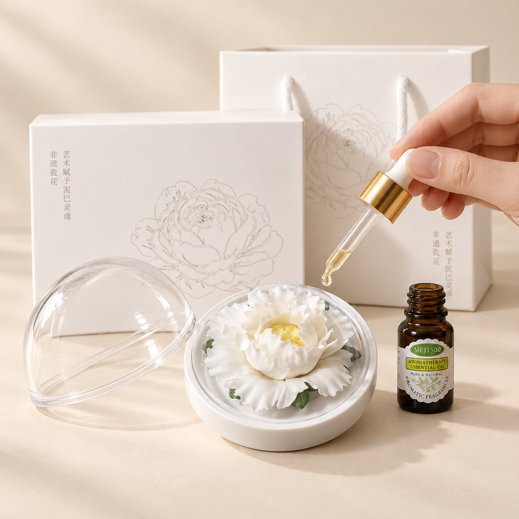White ceramic peony flower and oil gift set, large version — oil being dropped onto the ceramic flower petals