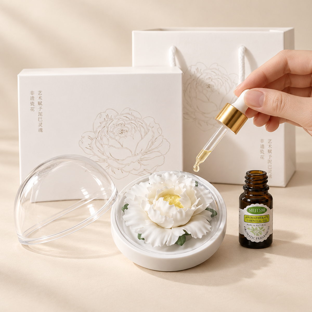 White ceramic peony flower and oil gift set, large version — oil being dropped onto the ceramic flower petals