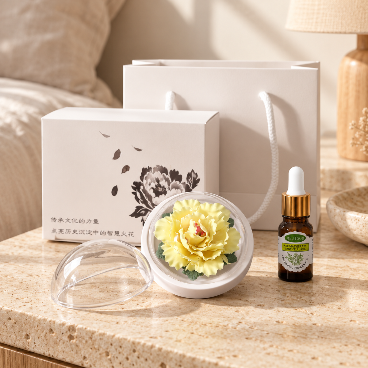 Yellow ceramic peony flower and oil gift set, small version — gift set styled on a bedside table in a beige room