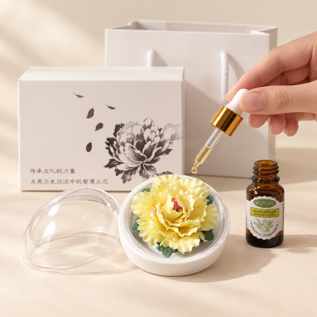 Yellow ceramic peony flower and oil gift set, small version — oil being dropped onto the ceramic flower petals