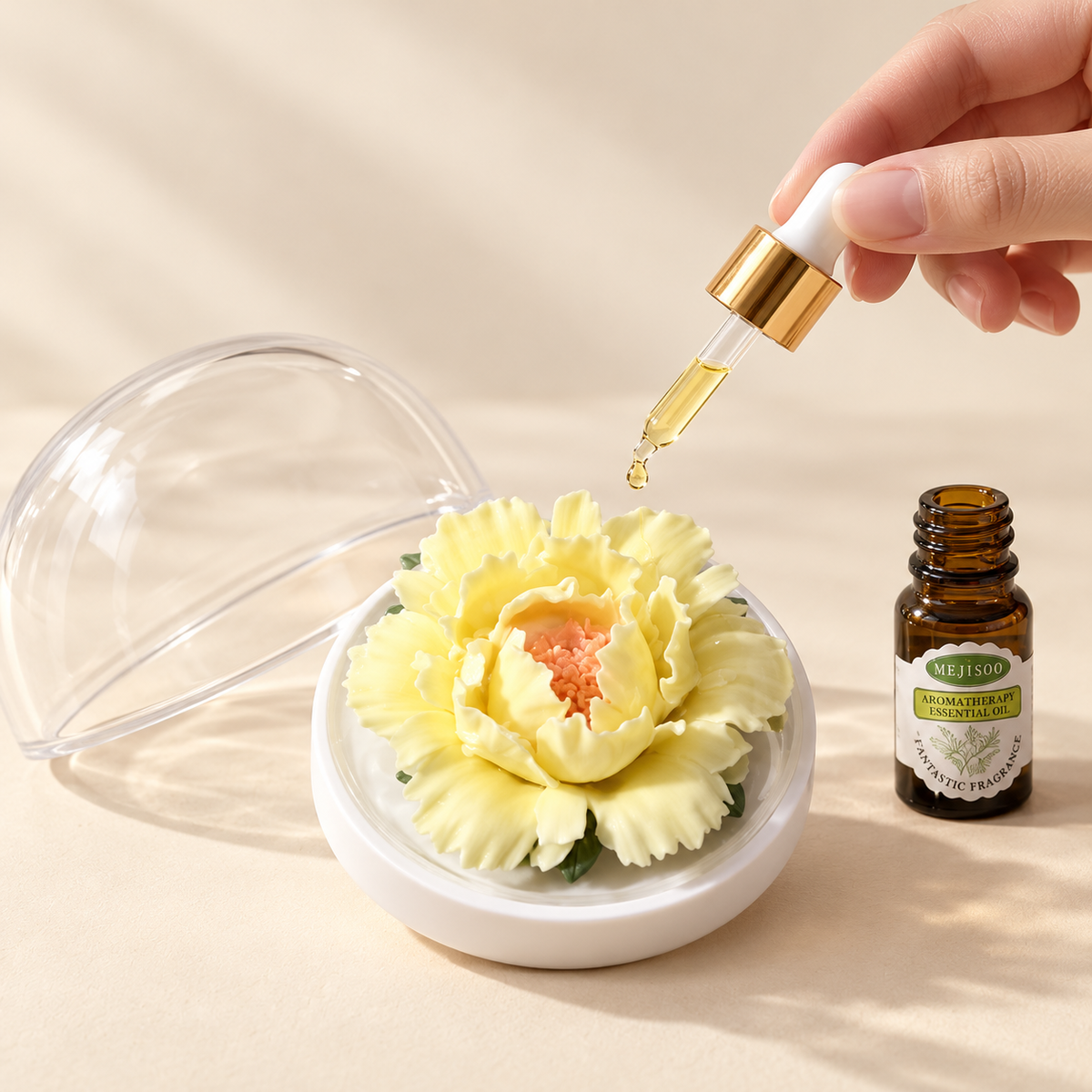 Yellow ceramic peony flower and oil gift set, large version — oil being dropped onto the ceramic flower petals
